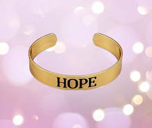 Load image into Gallery viewer, Hope Makes The World Go Round Gold Cuff Bracelet
